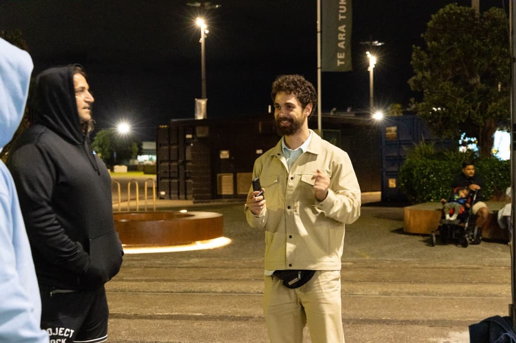 Paul talking with a small group at an evening Hang Challenge event